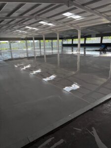 Wide view of self levelling epoxy resin floor with UV-stable top coat applied, ready for decorative flake.