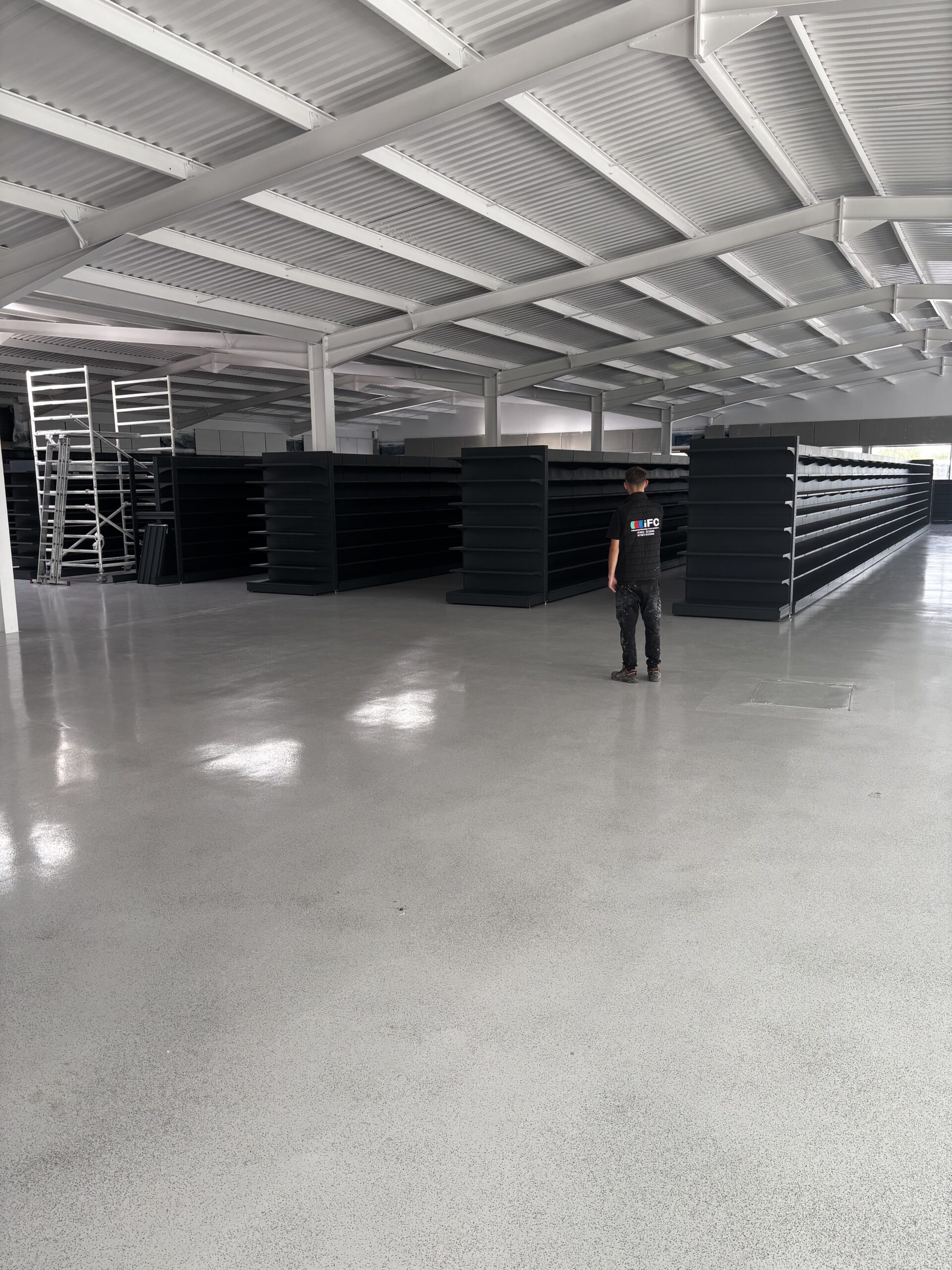 Wide view of completed self levelling epoxy resin floor with decorative flakes and UV-stable gloss finish in West Bromwich commercial space