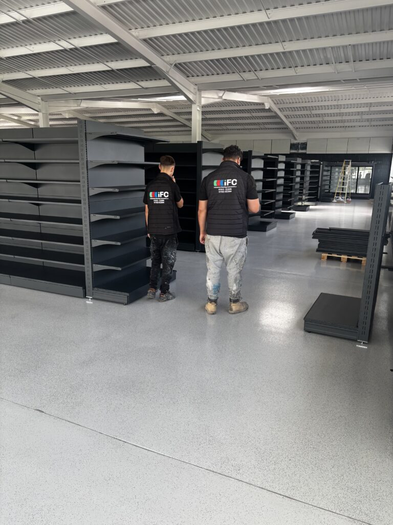 Industrial Flooring Contractors Ltd team standing on completed self levelling epoxy resin floor in West Bromwich commercial project