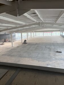 Smooth, level floor surface prepared and ready for DPM primer application during self levelling epoxy resin installation in West Bromwich commercial space