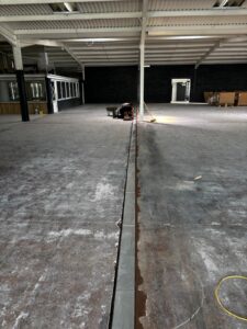 Neatly installed channel for electrical cables in West Bromwich supermarket self levelling epoxy resin floor